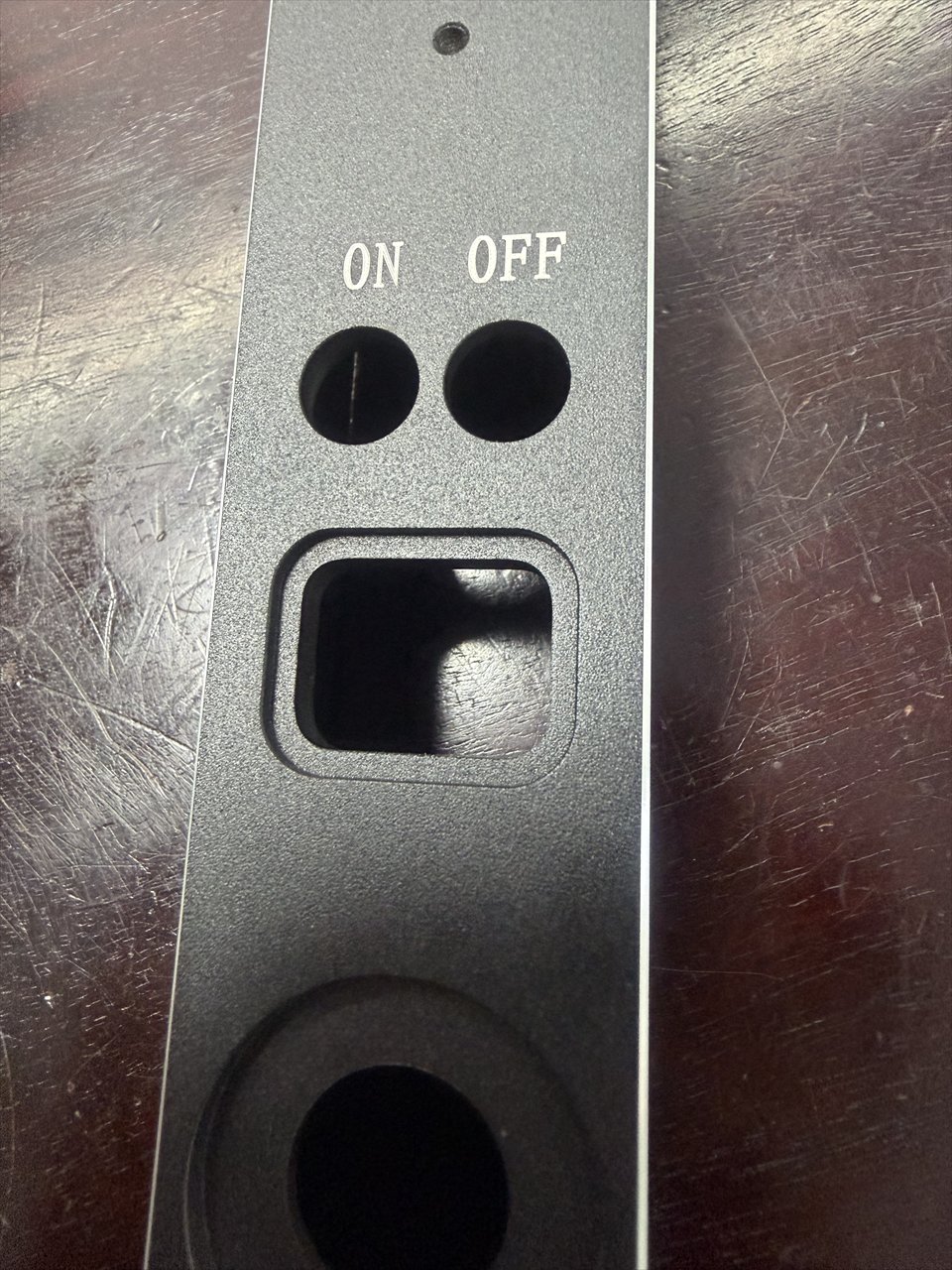 Close-up of a smart lock component showing ON and OFF control openings and finishing details